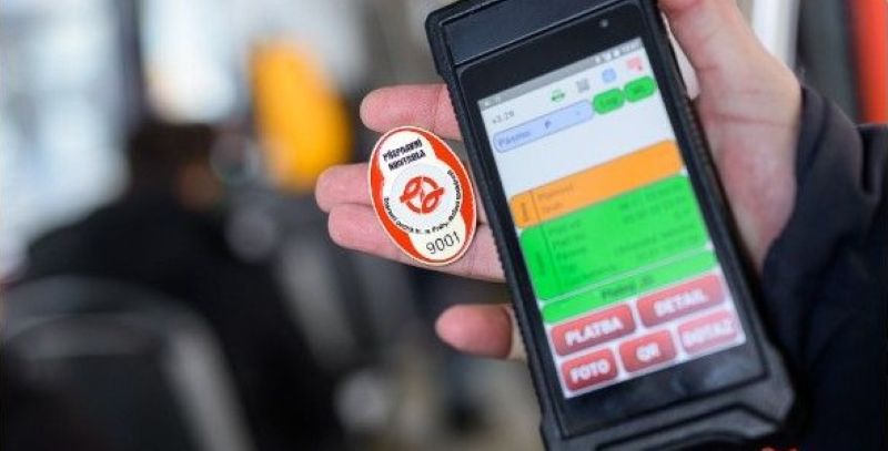 Prague ticket inspector holding a numbered inspection badge and a handheld ticket-checking device