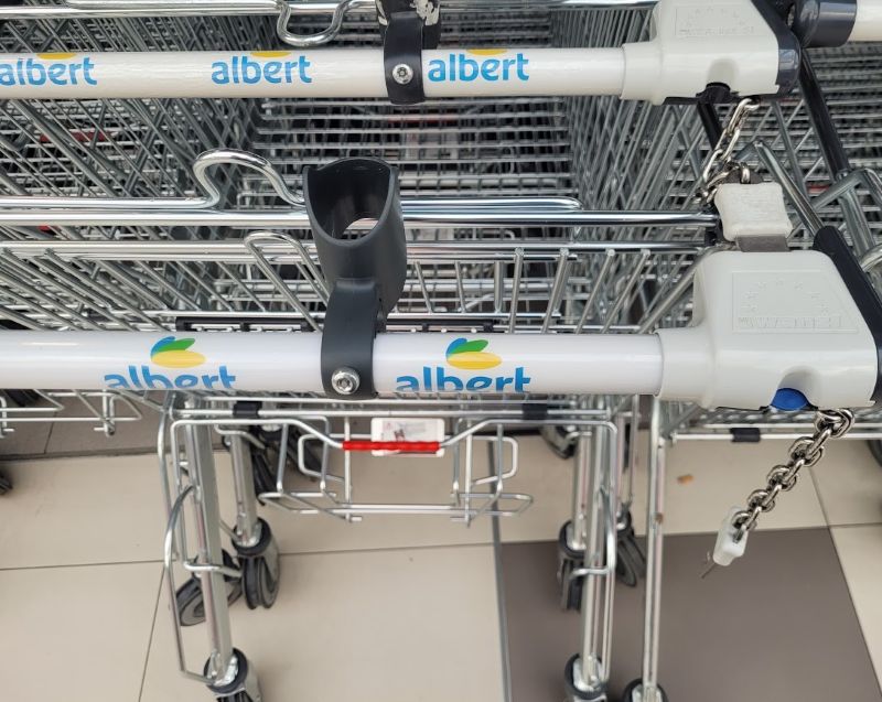 Supermarket cart with inserted plastic token